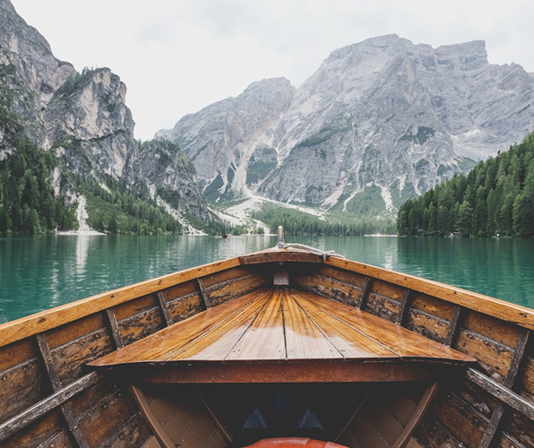 Wooden boat on a serene mountain lake